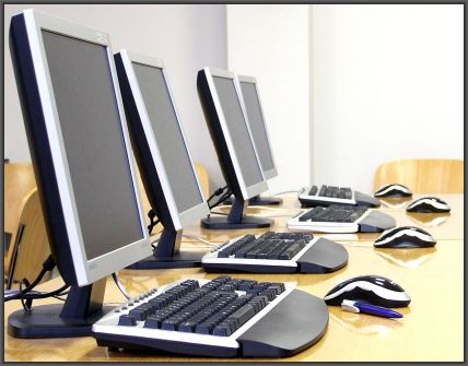 a line of computers at the library